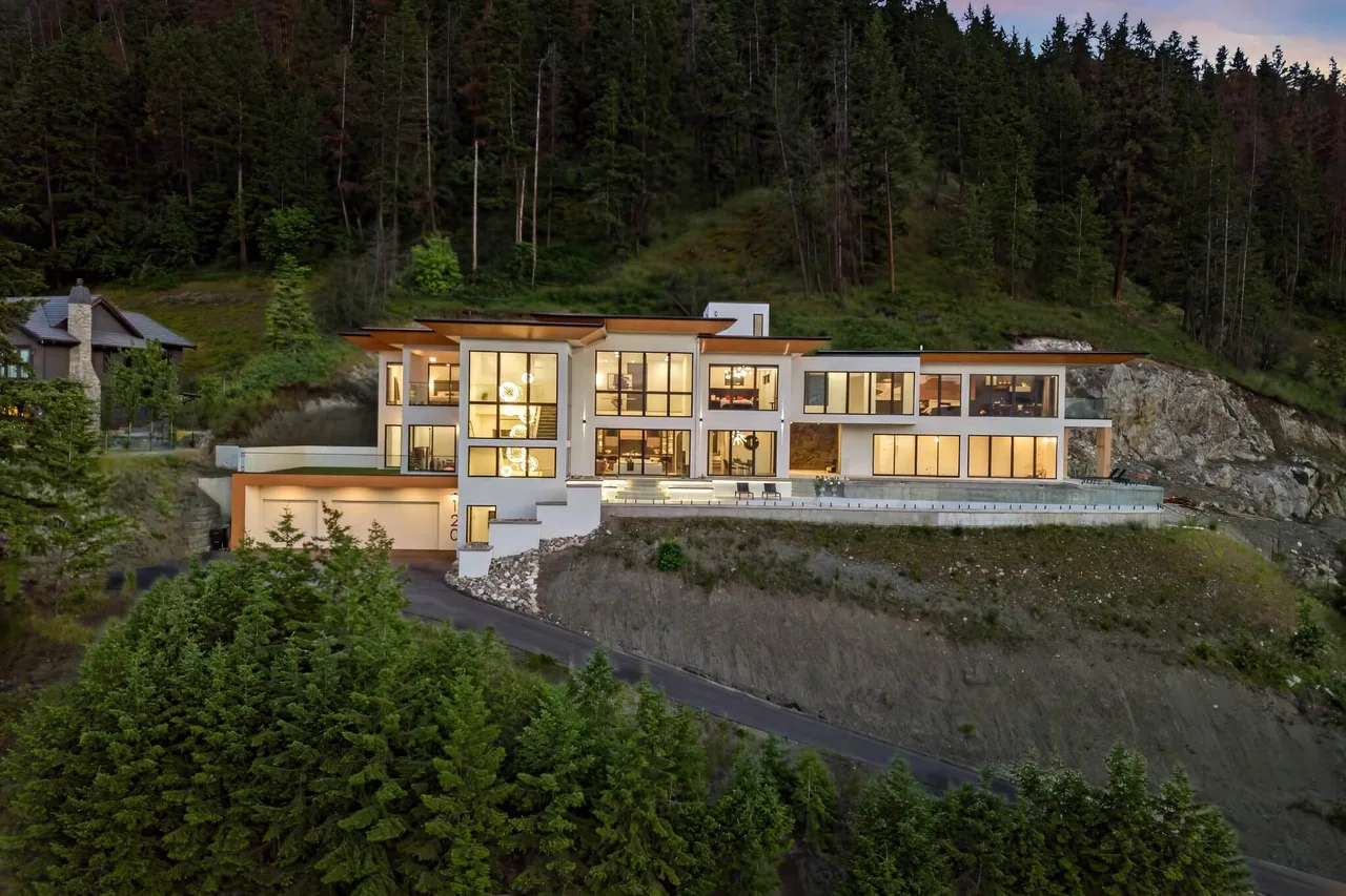 Sunset Boulevard: the home’s glass-walled levels lit up at dusk on its forested hillside