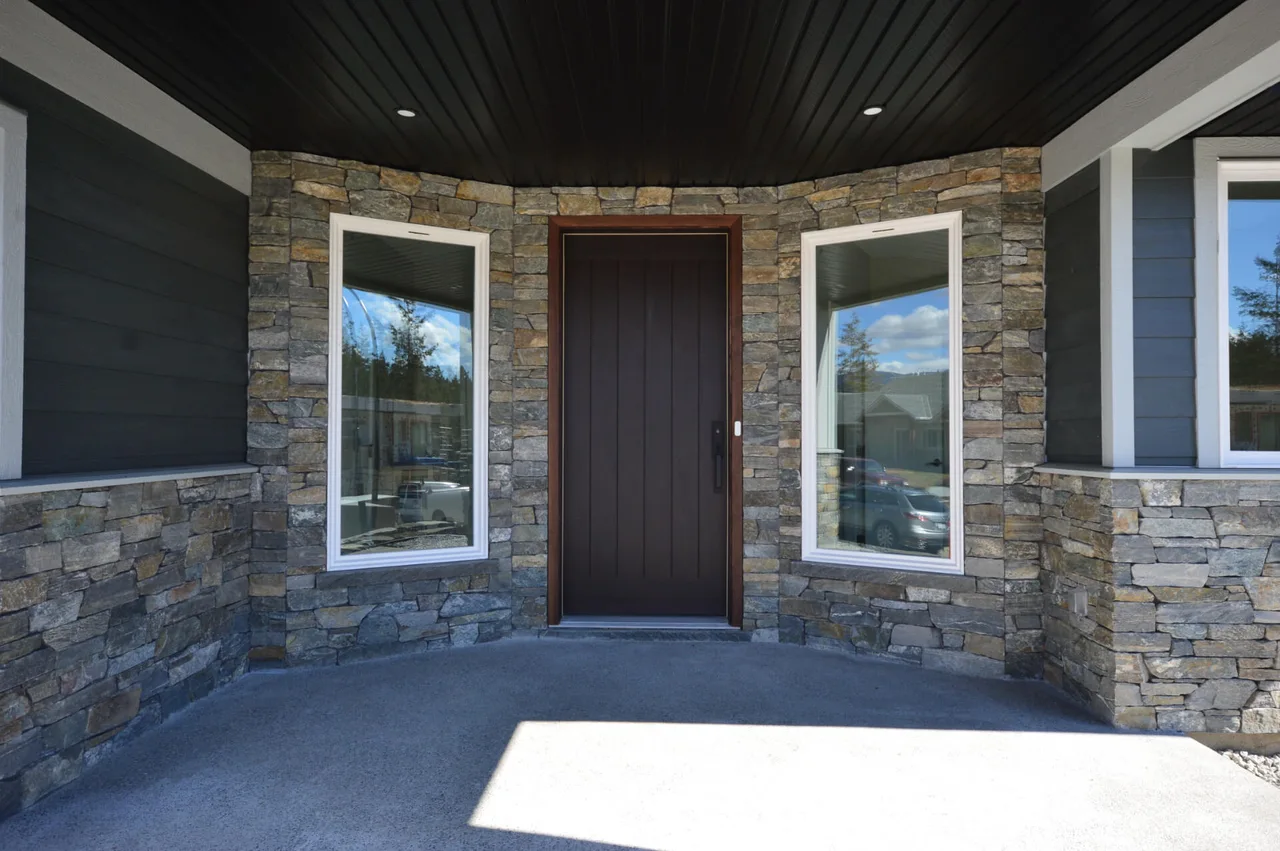 The covered entry, wrapped in locally made veneer stone around the front door