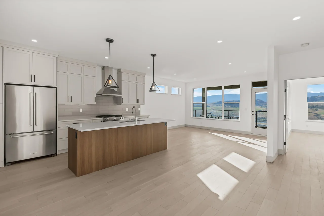 The open kitchen and living area, with a walnut island and windows onto the valley