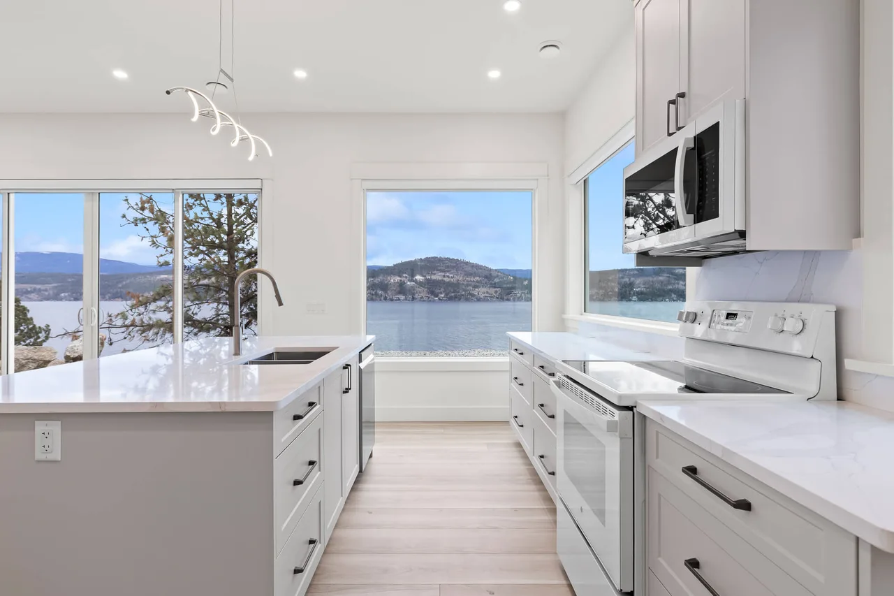 The kitchen counter running beneath windows onto the lake