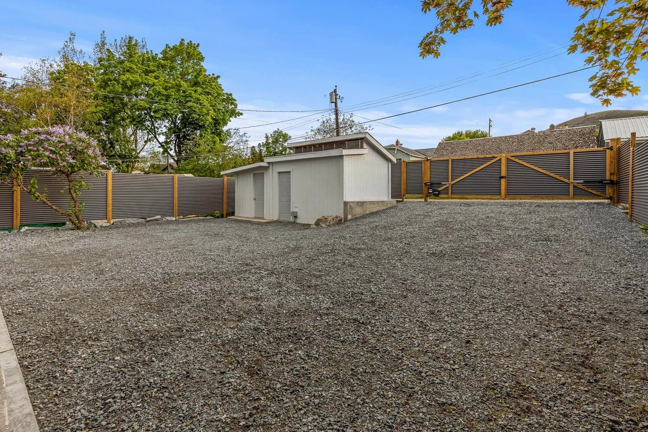 The fenced back yard and the garage beyond